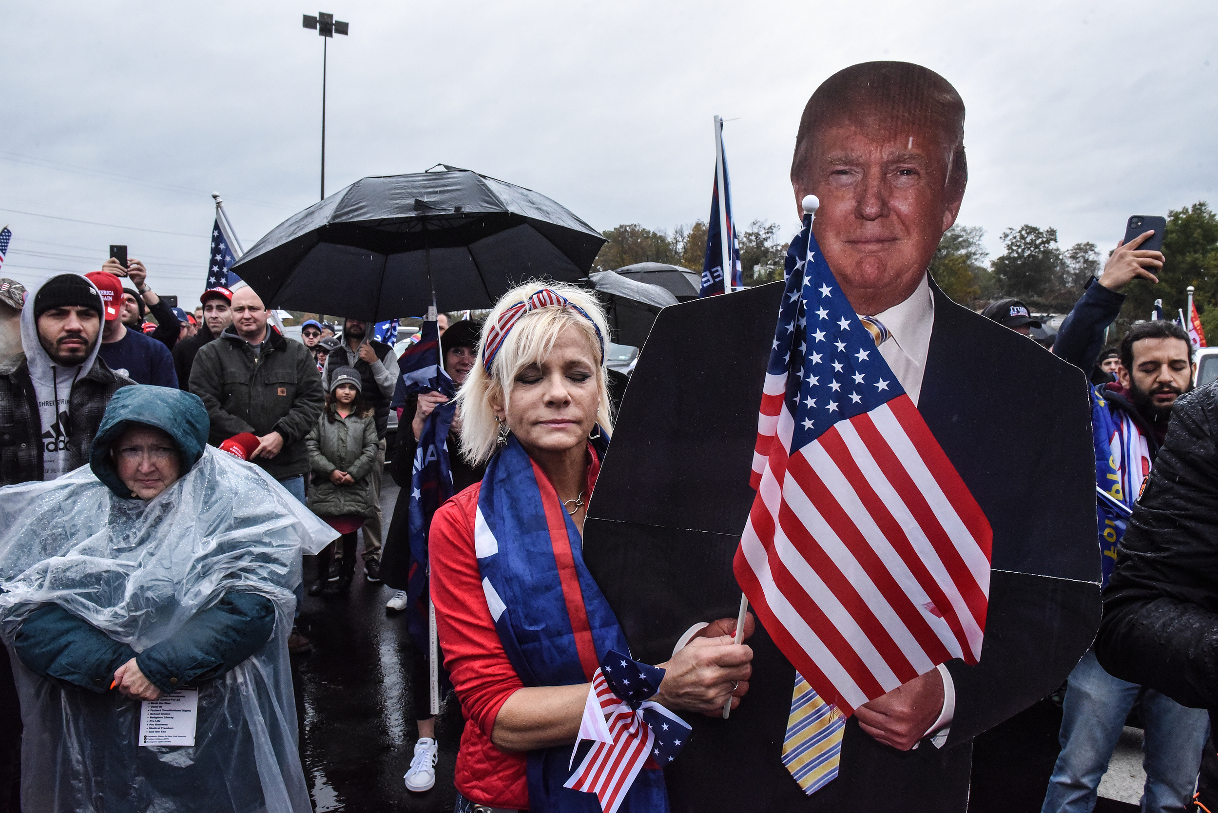 WEST NYACK, NY - NOVEMBER 01: A Trump supporter hugs a cut out of Donald Trump during a pro-Trump rally on November 1, 2020 in West Nyack, New York. With just two day left before the U.S. Presidential election, Trump supporters coordinated large caravans